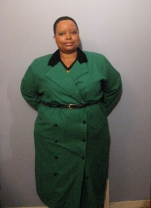 A front view of The Wicked Woman in her green funeral ensemble